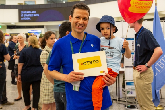 Staff enjoy the CTBTO exhibit with their children