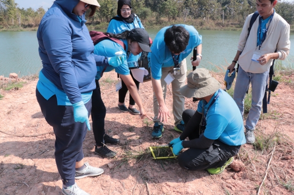 Trainees perform environmental sampling of vegetation during the RIC-24 field exercise. During an inspection, environmental sampling is used to identify radiation anomalies and narrow the inspection area.