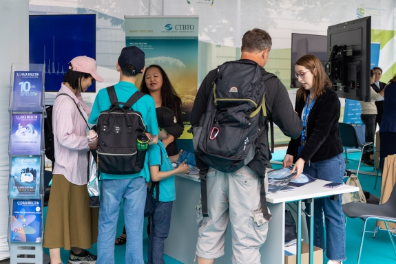 Staff discussing CTBTO’s work with visitors 