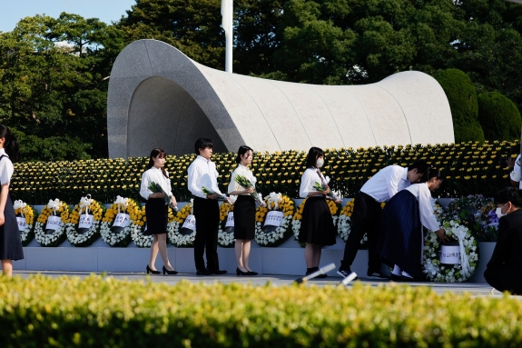 Local students dedicating flowers at ceremony