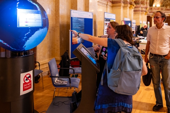 CTBTO Logistics Officer Birgit Scheffel demonstrating OmniGlobe to member of public