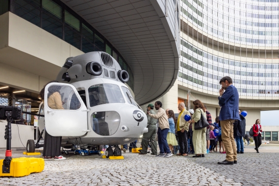 Visitors queueing to climb inside helicopter 