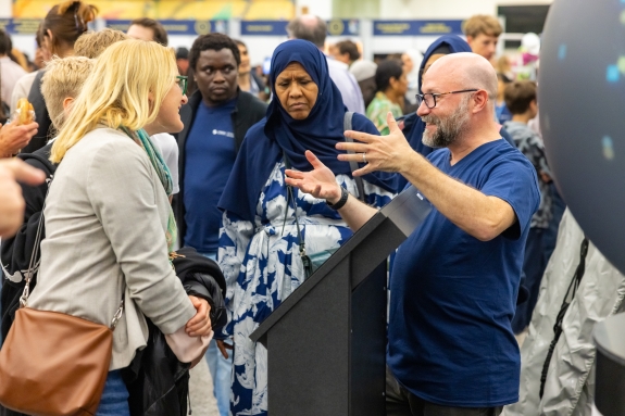 Public Information (PI) staff speaking to visitors using interactive OmniGlobe, which provides visual overview of CTBTO's IMS