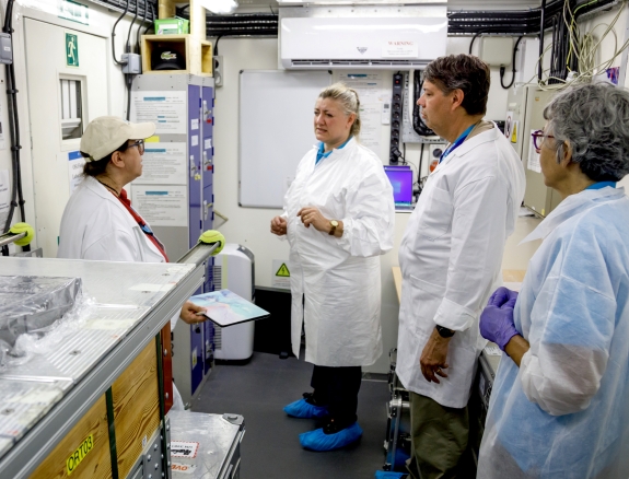 An Inspected State Party representative speaks to surrogate inspectors in the OSI field lab 
