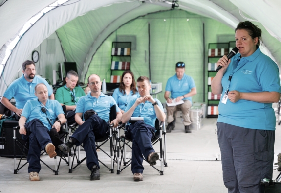 The Inspection Team Leader speaking to the Inspection Team during a daily meeting