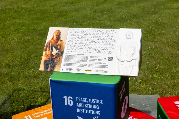 Tactile information board promoting accessibility of mural for individuals with disabilities