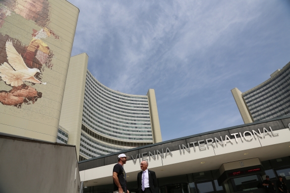 Executive Secretary Robert Floyd meeting with Magee in front of partially completed artwork at Vienna International Centre