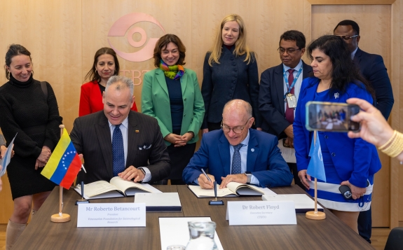 Executive Secretary Robert Floyd and Roberto Betancourt, Director of Venezuelan Foundation for Seismological Research (FUNVISIS) signing tsunami warning agreement