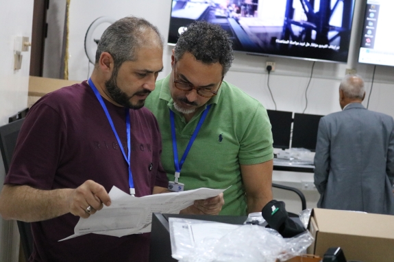 CTBTO staff consulting technical manuals during CBS setup 