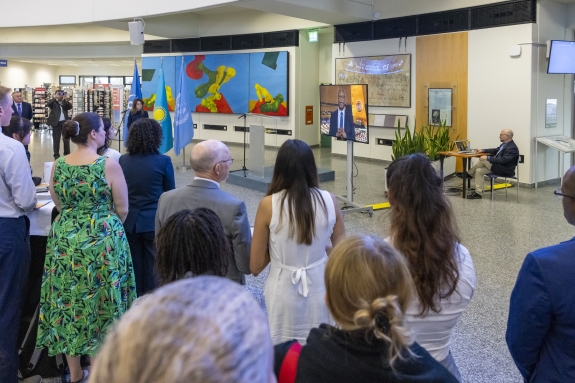 Crowd during IDANT commemoration event in Vienna watching and listening to PGA message