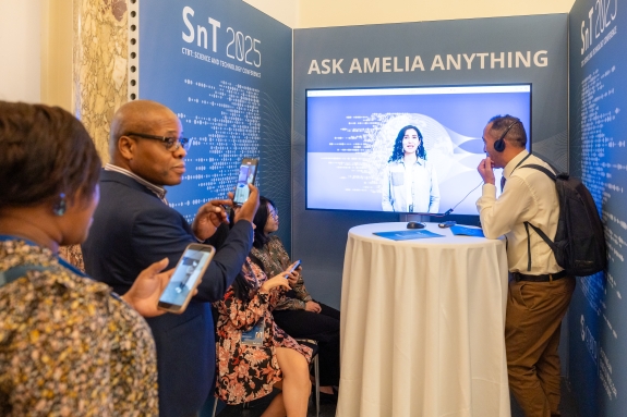 Participants speaking to AI support at Ask Amelia Anything booth 