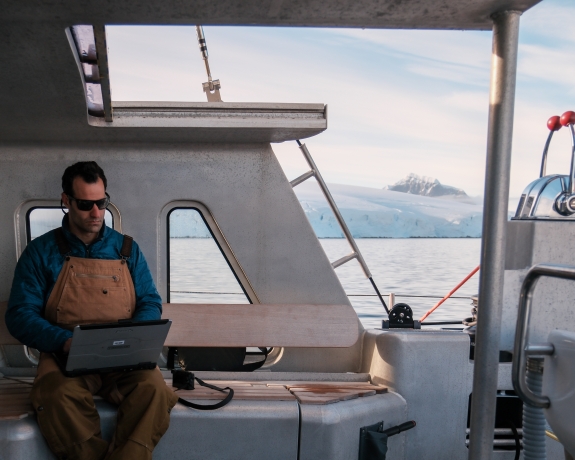 CTBTO Seismoacoustic Engineer, Gregory Brenn, reviewing data transmission as S/V Pelagic Amundsen navigates through Gerlache Strait, Antarctica