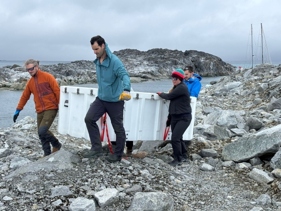 IS54 installation team carrying equipment vault to IS54 H1 element