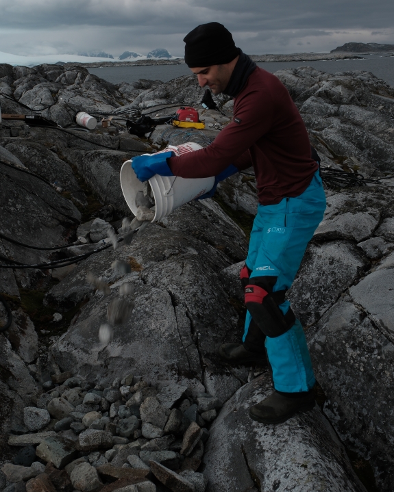 CTBTO Seismoacoustic Engineering Officer Gregory Brenn pouring rock for IS54 H4 element, creating level base for equipment vault
