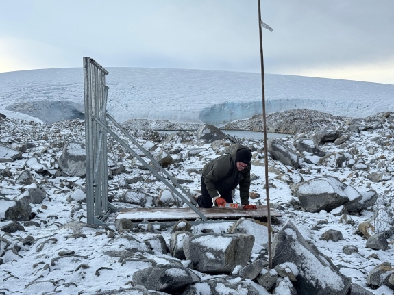Tony D'Aoust, UAF/WATC Power System Engineer installing equipment vault base at IS54 H1 element
