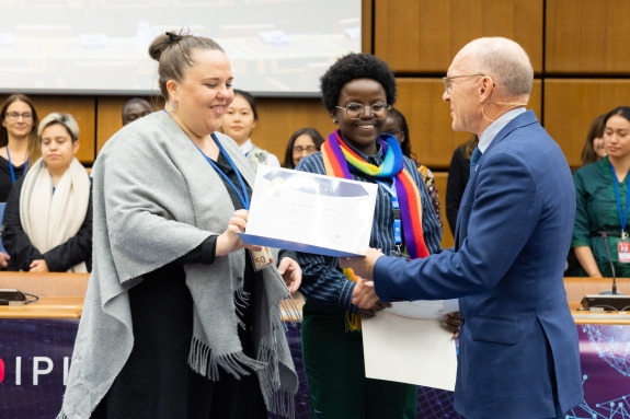 CTBTO Executive Secretary Robert Floyd presenting mentor and mentee pairs with certificates of completion for CTBTO Mentoring Programme