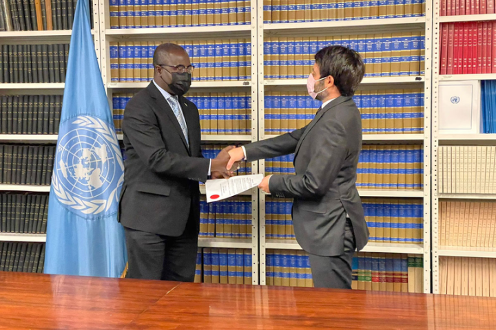 Lang Yabou, Permanent Representative of The Gambia to the UN, and David Nanopoulos, Chief of the Treaty Section of the UN Office of Legal Affairs.